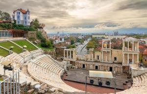 an amphitheater with a city in the background at Elegant 1-Bedroom Apartment in Plovdiv