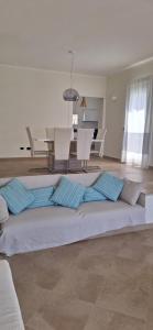 a large bed in a living room with a table and chairs at Villa Baja Sardinia in Baja Sardinia