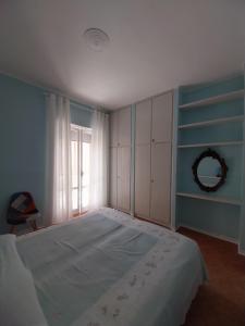 a bedroom with a large bed and a window at Appartamento MareBello in Sperlonga