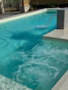 a swimming pool with blue water in it at Sun Holidays Home in Marina di Modica