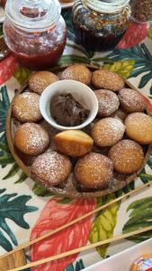 a plate of donuts and a bowl of chocolate on a table at Teanehi Bed & Breakfast in Hanga Roa