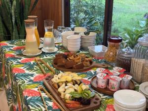 a table topped with plates of food and drinks at Teanehi Bed & Breakfast in Hanga Roa