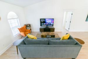 A television and/or entertainment centre at St Augustine Retreat - Pool, BBQ and Private Yard