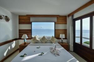 a bedroom with a bed and a large window at Neptune's Villa in Haad Rin