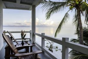 two chairs on a porch with a view of the ocean at Neptune's Villa in Haad Rin