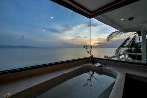a swimming pool with a view of the ocean at Neptune's Villa in Haad Rin