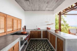a kitchen with a stove and a counter top at Casa La Distancia Mazunte Sustainable House in Mazunte