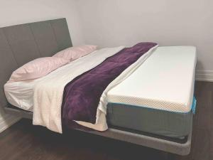 an unmade bed in a room with at cozy private guest suite in Richmond Hill +43 photos