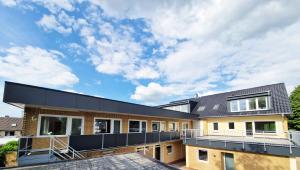a house with a black roof at WeserPension in Brake