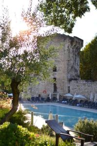 a swimming pool in front of a stone building at Cocon provençal dans le centre historique in Aix-en-Provence