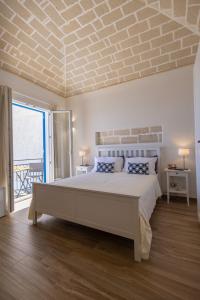 a bedroom with a large bed with a brick ceiling at Marettimo Vacanze in Marettimo