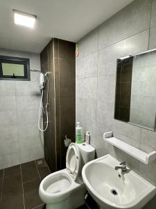 a bathroom with a white toilet and a sink at Stay 3B2R Meritus Residensi Perai in Perai +16 photos