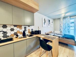 a kitchen with a desk and a bed in a room at Loftowe Love in Kołobrzeg
