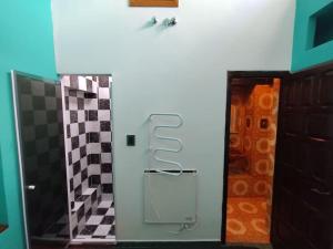 a bathroom with a door and a wall with tiles at Pintoresco departamento full equipado in Buenos Aires