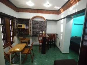 a room with a table and chairs and a kitchen at Pintoresco departamento full equipado in Buenos Aires
