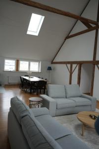a living room with two couches and a table at The nestie in Walhain-Saint-Paul +12 photos