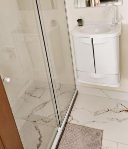 a bathroom with a shower and a sink at Cantinho na Serra - Apartamento in Santa Maria Madalena +14 photos