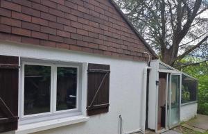 a white house with windows and a brown roof at studio gien in Gien