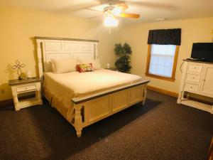 a bedroom with a large bed and a television at Briarstone Lodge Condo 13D by Eden Crest in Pigeon Forge