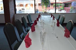 a long table with red napkins and wine glasses on it at The Inn at Crumpin-Fox in Bernardston