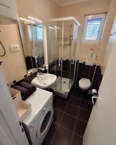 a bathroom with a toilet sink and a shower at Lucky Studios in Herceg-Novi +59 photos