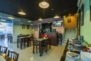 a dining room with tables and chairs in a restaurant at Monoloog Hotel Solo in Solo