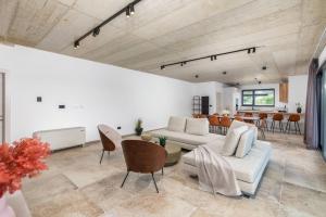 a living room with a couch and a table at Villa Butoniga Hills in Pazin