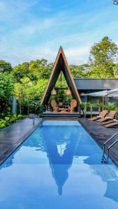 a house with a swimming pool with a house at Namu Garden Hotel & Spa in Puerto Viejo