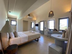 a bedroom with a bed and a table and windows at Relaxing Home in Pirgos