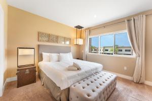 a bedroom with a large bed and a large window at 7458 Magic Village 3suites 8guests jacuzzi 8 min Disney in Orlando +66 photos