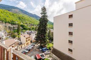 a view from the balcony of a building with a tree at Studio central Brides-les-Bains in Brides-les-Bains