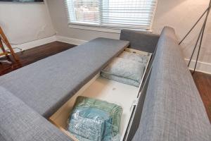 a couch with a box in a room at #StayinMyDistrict Heritage House Pet Friendly Apartment in Coos Bay