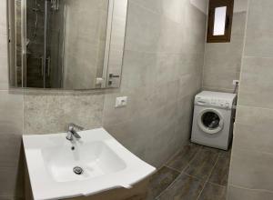 a bathroom with a sink and a washing machine at Casa Bel Duomo in Gerace +15 photos