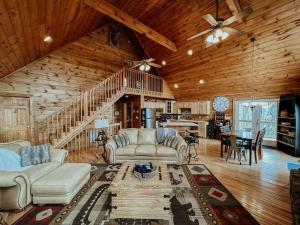a living room with couches and a dining room at Spacious, dog friendly cabin in Blowing Rock, NC in Blowing Rock