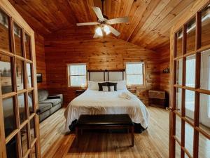 a bedroom with a bed and a ceiling fan at Spacious, dog friendly cabin in Blowing Rock, NC in Blowing Rock