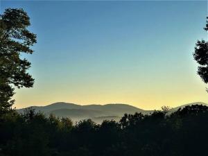a view of the mountains with the sun setting in the background at Spacious, dog friendly cabin in Blowing Rock, NC in Blowing Rock