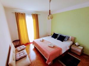 a bedroom with a large bed and a couch at B&B "Retro Gusto " in Pićan +18 photos