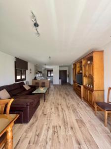 a living room with a couch and a table at El Hondón del Lugar in Hoyos