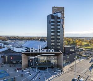 a large building with a hoglania sign on it at Good Morning+ Halmstad in Halmstad