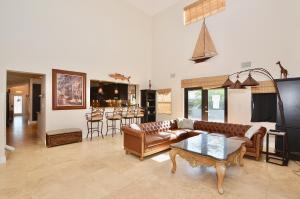 a living room with a couch and a table at Riverfront Luxury Pool & Hot Tub fishing paradise near beaches Mets Stadium in River Park