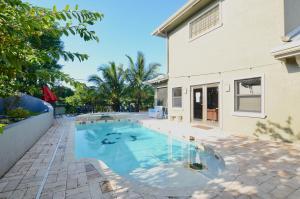 a swimming pool in the backyard of a house at Riverfront Luxury Pool & Hot Tub fishing paradise near beaches Mets Stadium in River Park