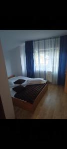 Ein Bett oder Betten in einem Zimmer der Unterkunft Popasul Drumețului Transfăgărășan