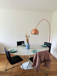 a dining room table with chairs and a lamp at Charming Apartement Luxembourg City Center, Parking, Balcony in Luxembourg
