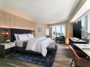 a hotel room with a large bed and a desk at The Westin San Diego Bayview in San Diego