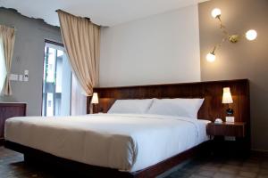 Postel nebo postele na pokoji v ubytování Flor de Mayo Boutique Hotel, Spa & Restaurant