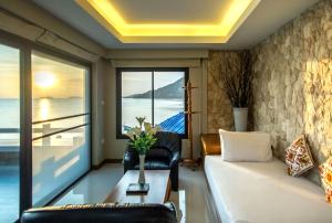 a living room with a couch and a view of the ocean at Neptune's Villa in Haad Rin
