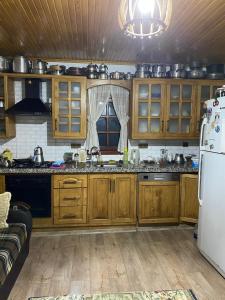 a kitchen with wooden cabinets and a white refrigerator at Yücebaş Konağı in Fatsa +23 photos