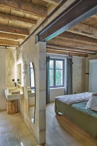 a bedroom with a large bed and a window at L'Arlésienne in Arles