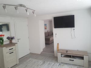 a living room with a flat screen tv on a wall at Apartman Memo in Sarajevo