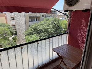 a balcony with a wooden bench on a building at Lorena Apartment in Šibenik